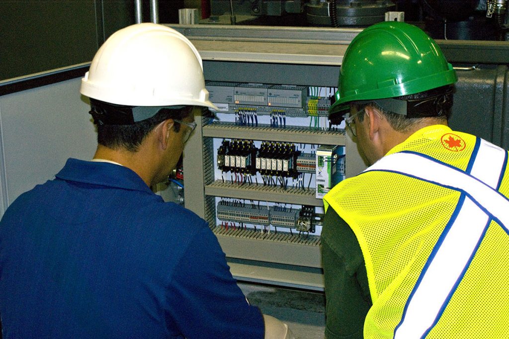 WIR technicians working on equipment at an industrial facility